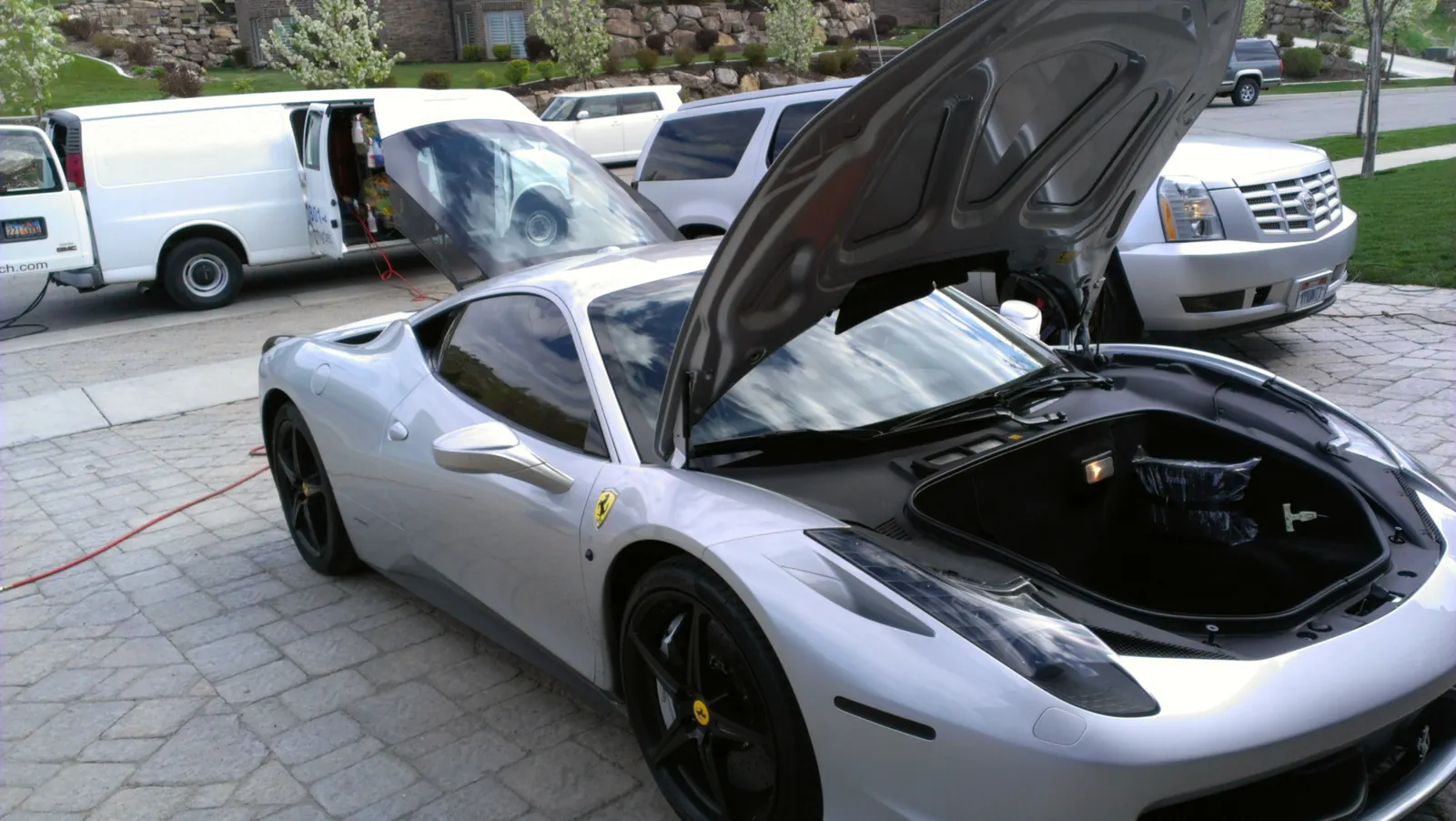 A freshly detailed silver sports car in a driveway